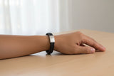 Black braided leather bracelet with a silver clasp on wrist