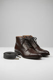 Pair of brown shoelaces with metal eyelets on a white background