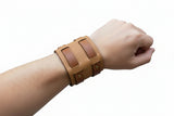 Light brown leather wrist support with velcro fastening
