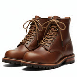 A coiled heavy-duty light brown leather shoelace with metal tips.
