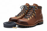 Pair of brown leather boots with navy and grey stripe laces on a white back groundbackground