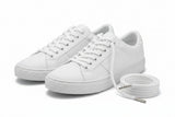 Pair of white sneakers wih white laces